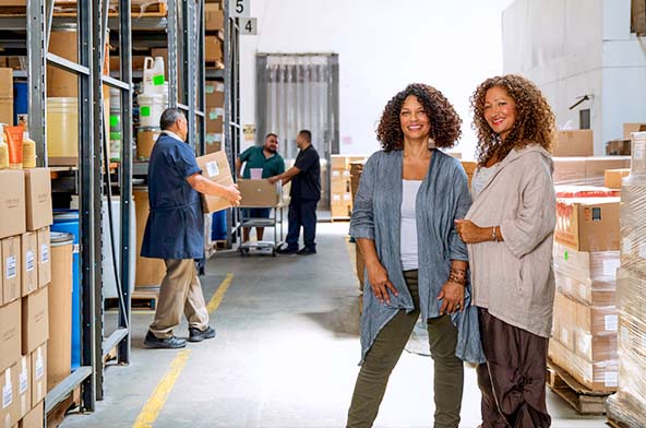 Women business owners posing together smiling