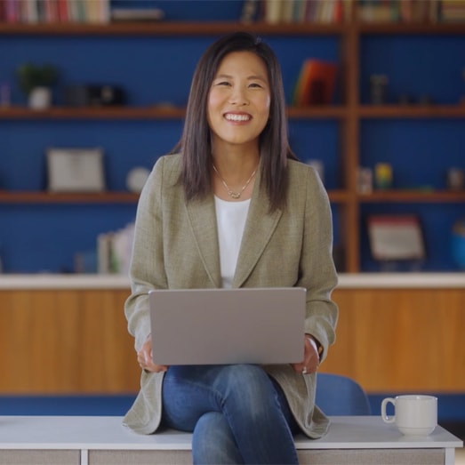 A person sitting on a laptop computer.