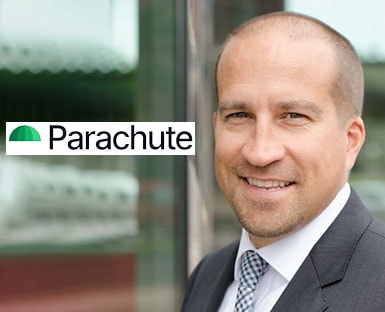 A person in a suit and tie sitting on a bench.