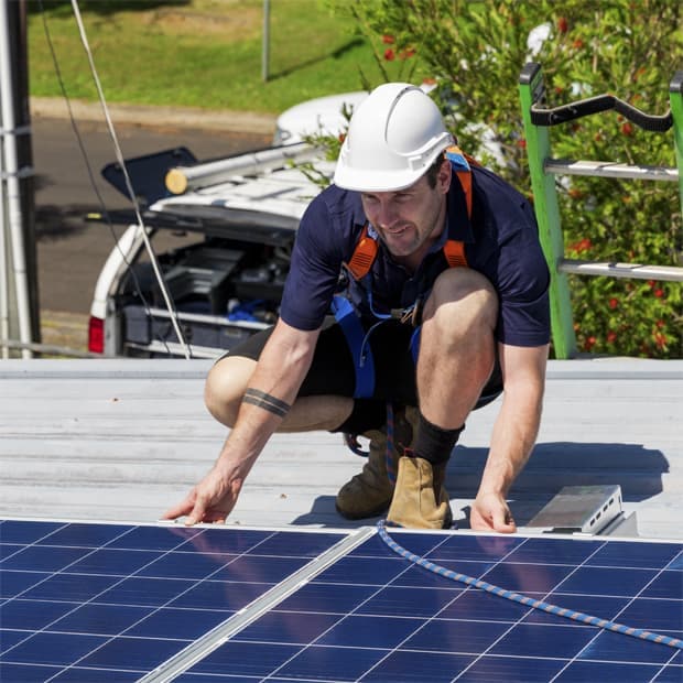 Technician installing solar panels