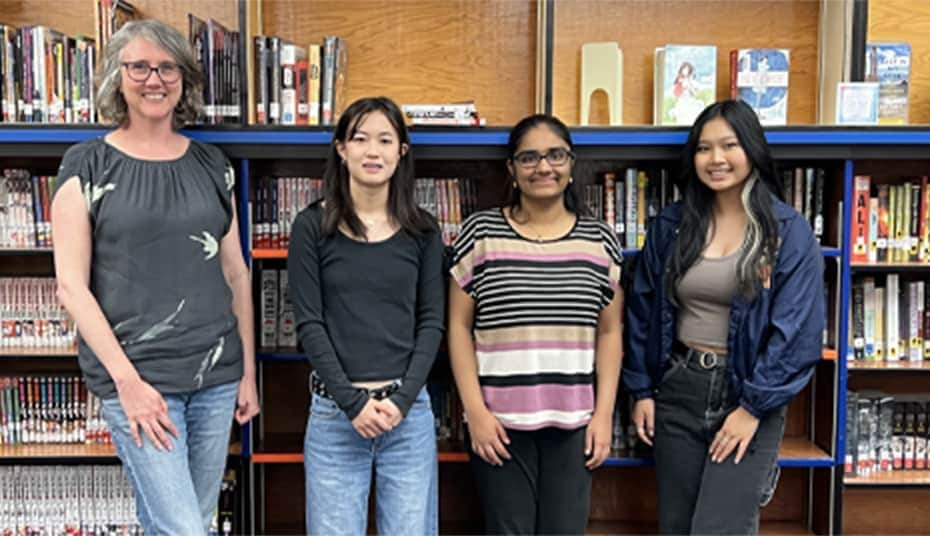 Group of students and their teacher in the library