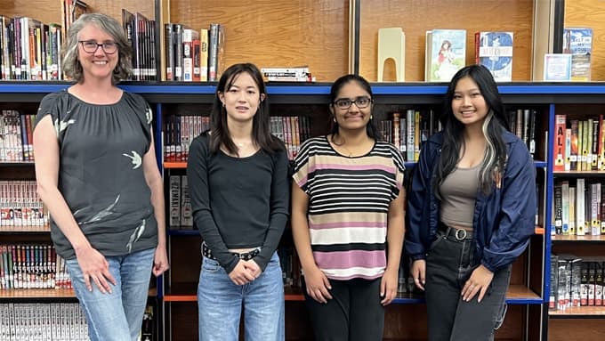 Group photo of team Enlighteners in a library