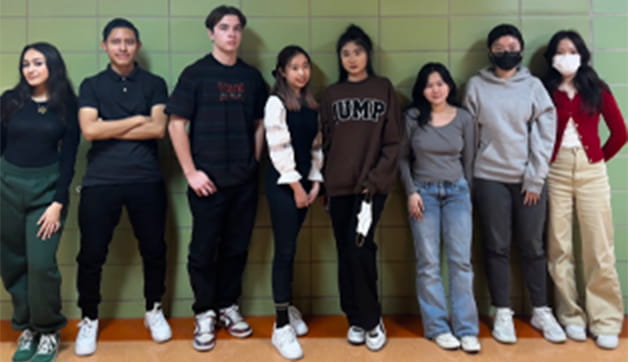 A group of people standing in a room.