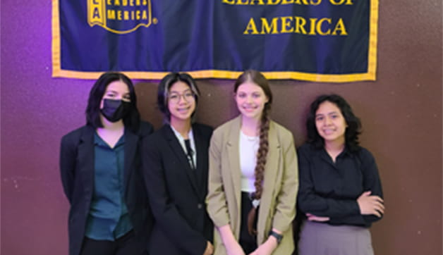 A group of people in business attire posing for a picture.