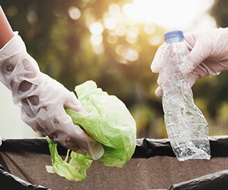 photo of hands picking up trash