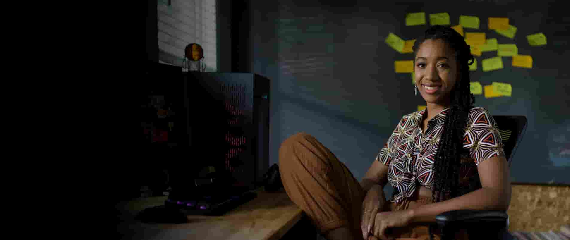 Woman sitting in front of a desk.