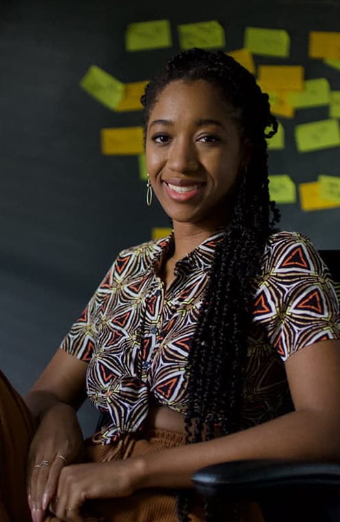 A person sitting on a chair and smiling