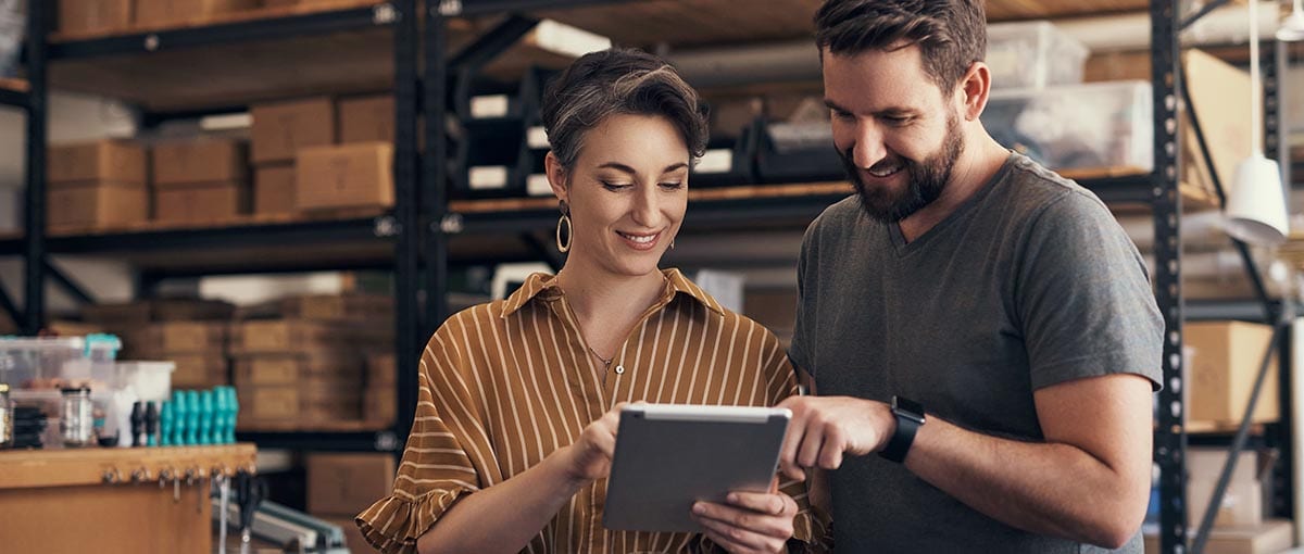 A person and person holding a laptop computer.