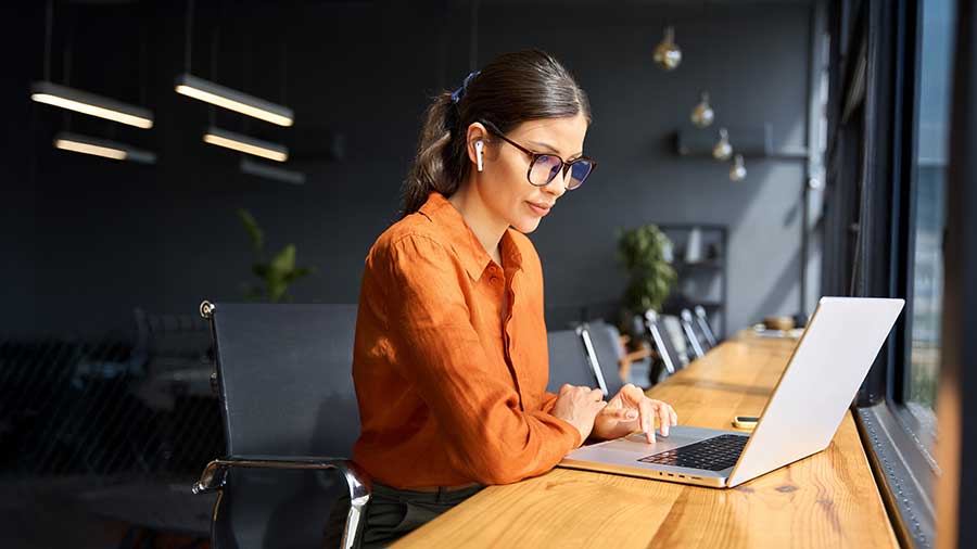 A person sitting at a desk with a laptop.