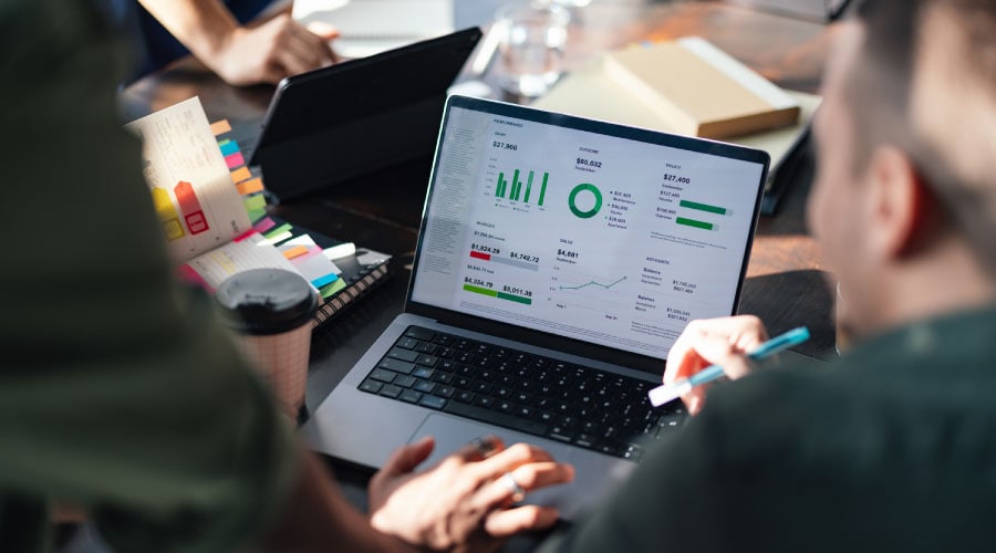 An image showing a finance team reviewing business performance dashboards.