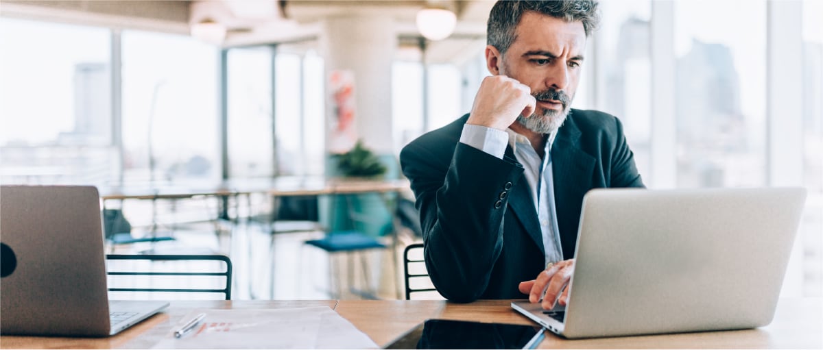 A person sitting at a table with a laptop.
