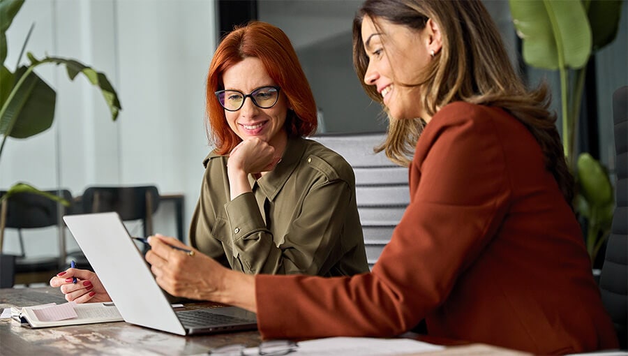 An image of two business professionals evaluating a cash flow dashboard.