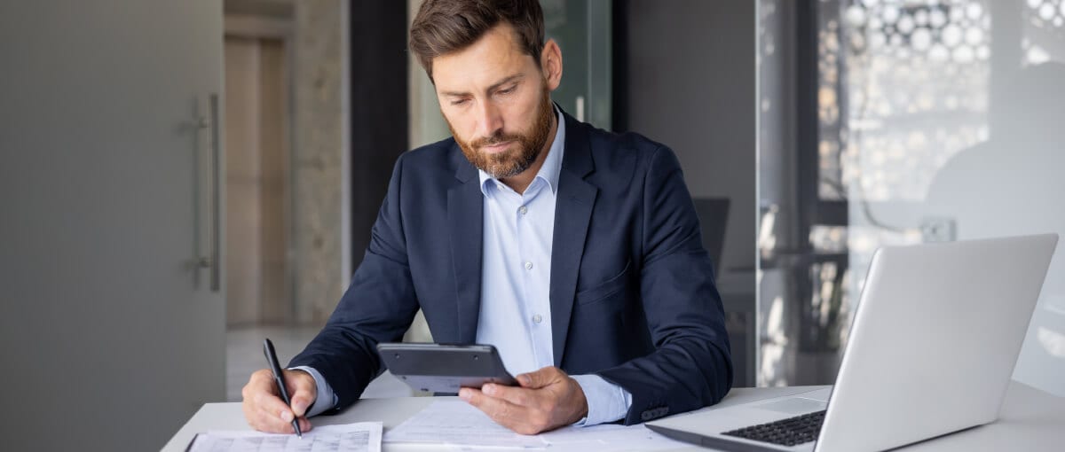 A person sitting at a desk with a laptop.