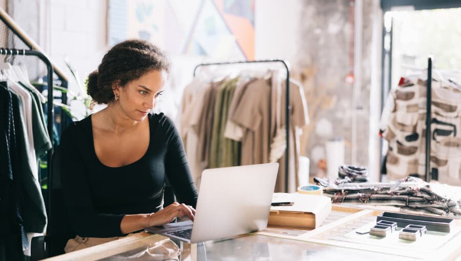 A person sitting at a desk with a laptop.
