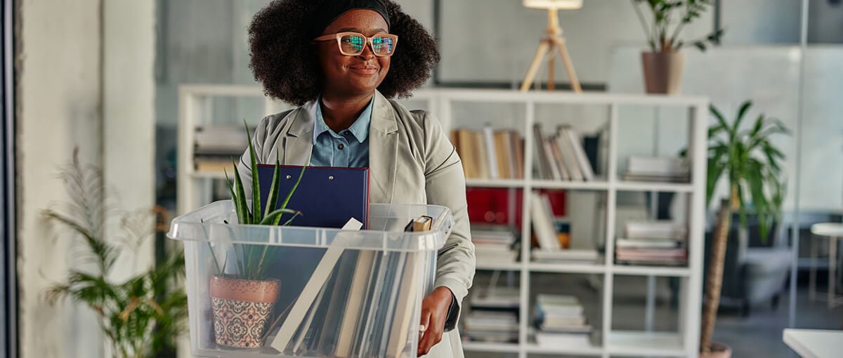 A person in a red dress is holding a glass.