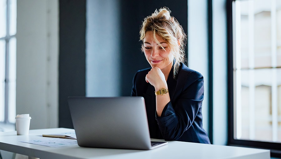 A person sitting at a desk with a laptop.