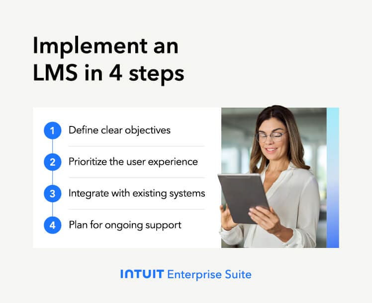 A person is on a stage with a laptop.