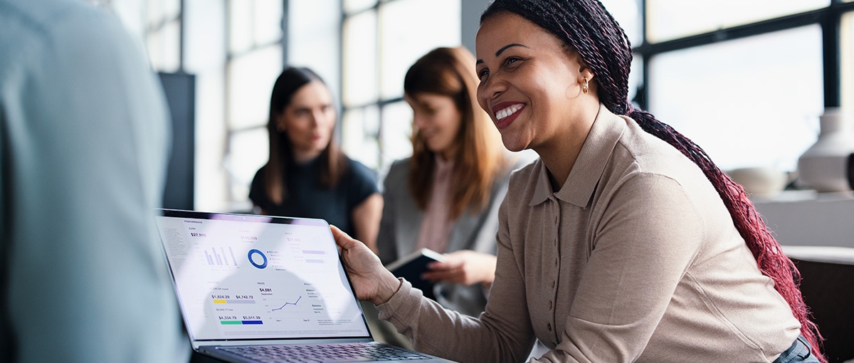 A person sitting at a table with a laptop.
