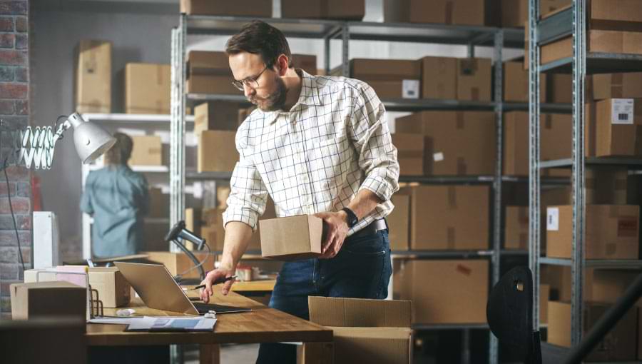 A business owner reviewing shipping options for a small package.