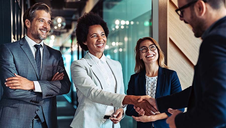 Executives work on a business-to-business-to-deal.